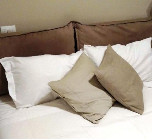 a pile of pillows sitting on top of a bed at Acetylene B&B in Rapolano Terme