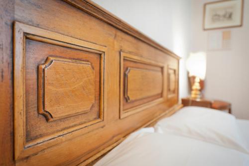 a wooden headboard of a bed in a bedroom at Hotel Martelli in Florence