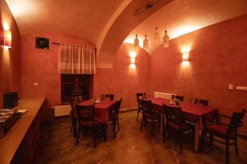 a dining room with red tables and chairs at Penzion U řízků in Rapotín