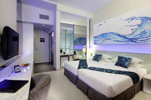 a hotel room with a large bed and a television at Vivatel Kuala Lumpur in Kuala Lumpur