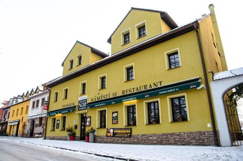 a yellow building on the side of a street at pension N.10 in Frymburk