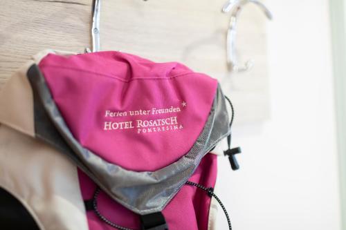 a pink bag is hanging on a wall at Hotel Rosatsch in Pontresina