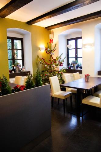 a christmas tree in a restaurant with a table and chairs at pension N.10 in Frymburk