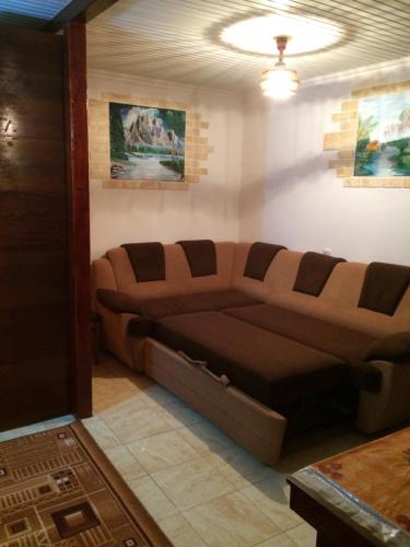 a couch in a living room with a ceiling at Vasile Alecsandri 60 ap 49 in Chişinău