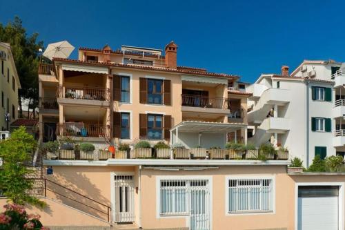 a large apartment building with plants on the balcony at ArtApArt Z in Rabac