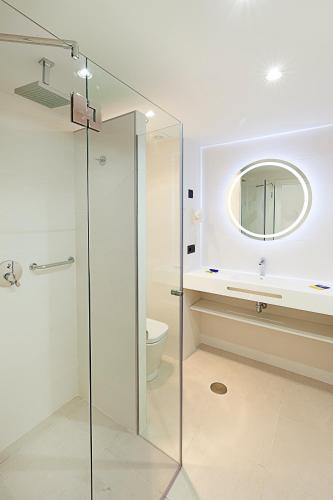 a bathroom with a glass shower and a toilet at Benidorm Centre - Adults Only in Benidorm