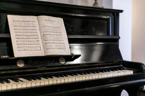 an open book sitting on top of a piano at Hotel Pocho in San Vito lo Capo