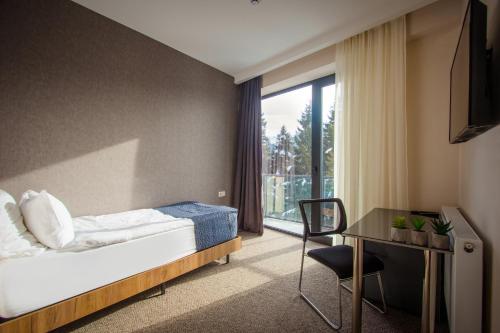 Voodi või voodid majutusasutuse AuRoom Bakuriani Resort toas