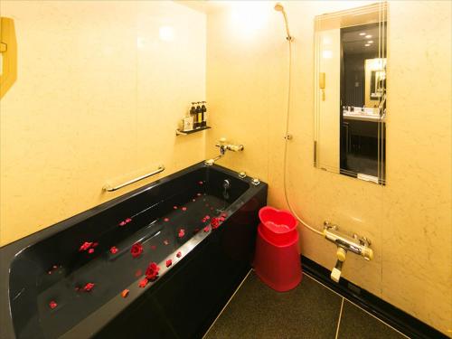 a bathroom with a sink and a bathtub at Hotel Renaissance Sendai (Leisure Hotel) in Sendai