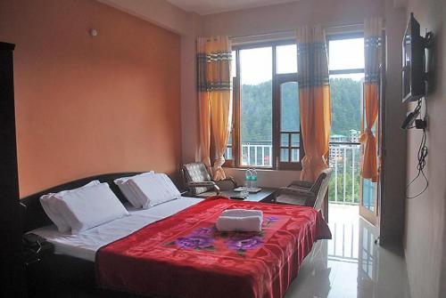 a bedroom with a bed and a large window at Mountain and Moon, Dharamkot in Dharamshala