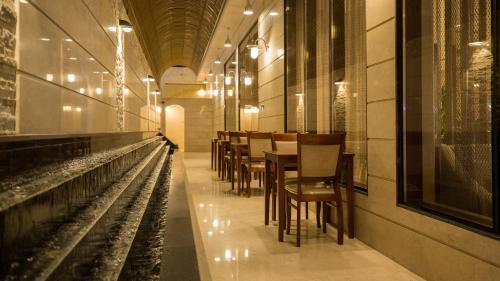 a row of tables and chairs in a restaurant at Jiwar Almasi Hotel in Jeddah