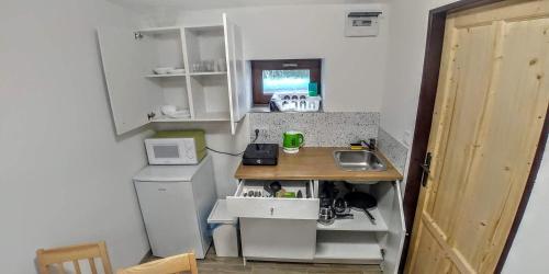 a small kitchen with a counter and a sink at Apartmany Centrum in Pavčina Lehota