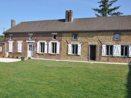 a large brick house with a large yard at Spacious holiday home in Sormery with pool in Sormery