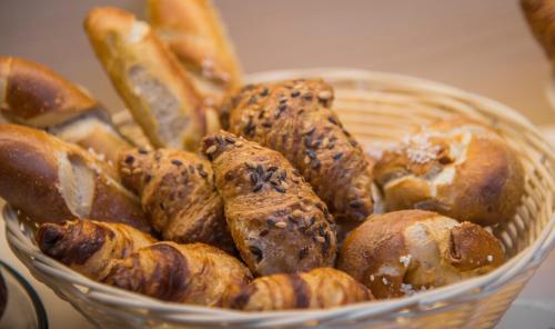 a basket filled with different types of bread at Apartment Hotel Konstanz in Konstanz