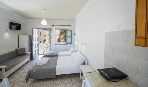 a small room with a bed and a couch at Zacharakis Studios in Kamari
