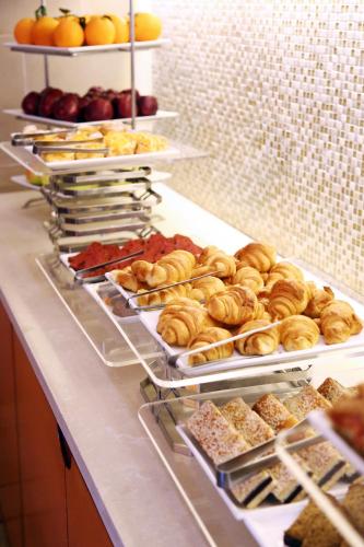 a buffet line with different types of pastries and fruit at Ramada Plaza by Wyndham Beirut Raouche in Beirut