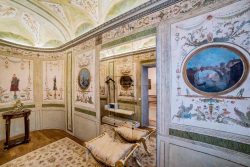 a room with paintings on the walls at Hotel Nani Mocenigo Palace in Venice