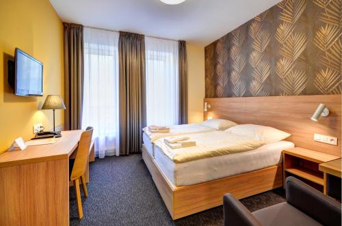 מיטה או מיטות בחדר ב-Hotel Helios