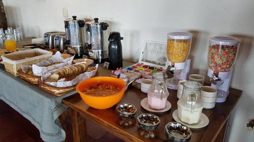 a table with food and other items on it at La Posta Hotel y refugio De Montana in Mina Clavero