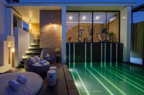 a swimming pool in a house with a swimming pool at Chala Number 2 Art and Gallery in Chiang Mai