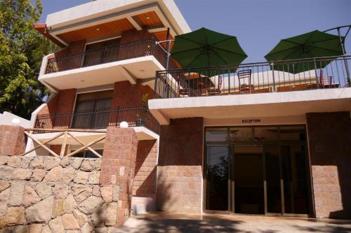 a building with chairs and umbrellas on top of it at Tabor Hotel Lalibela in Lalībela
