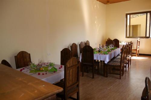 a dining room with a table and chairs with white tablecloths at Tabor Hotel Lalibela in Lalībela