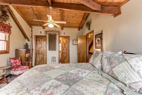 a bedroom with a bed and a ceiling fan at The Grey Moose in Blairsville