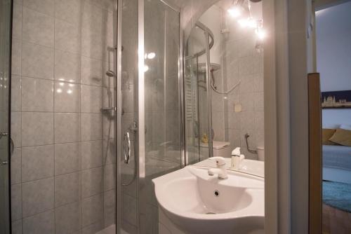 a bathroom with a sink and a shower at Panorama apartment in Budapest