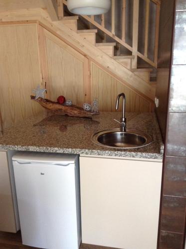 a kitchen with a sink and a counter top at La Cabaña de Catalina in Sotres