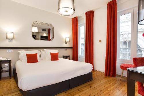 a hotel room with a bed and a dresser at Hotel Albert 1er in Toulouse