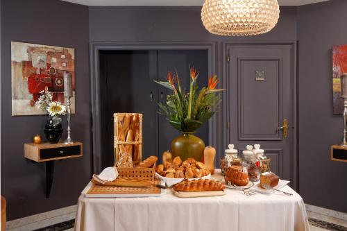 a table with bread and pastries on top of it at Hotel Restaurant Crystal in Erstein