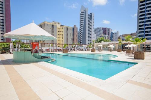 a swimming pool in the middle of a city at Oasis Atlantico Fortaleza in Fortaleza