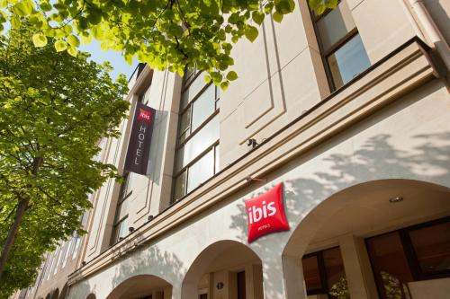 a building with a bus sign on the side of it at ibis Rueil-Malmaison Centre in Rueil-Malmaison