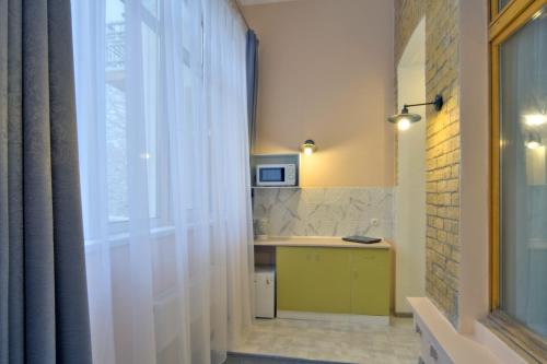 a kitchen with a window and a sink and a counter at Grand Apartments in Kyiv