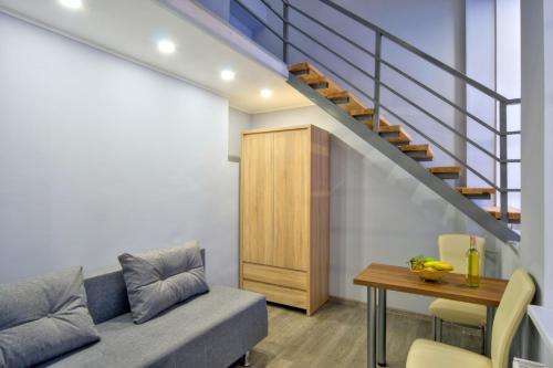 a living room with a couch and a table at Grand Apartments in Kyiv
