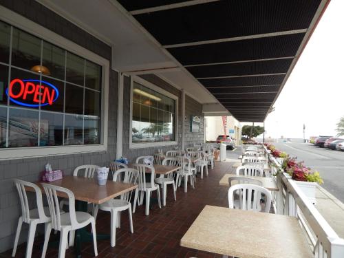 a restaurant with tables and white chairs on the sidewalk at The Spinnaker in Ocean City