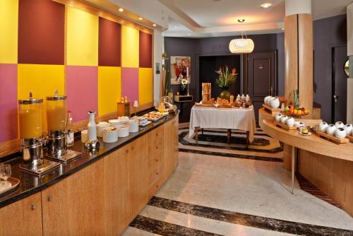 a buffet line with a table in a restaurant at Hotel Restaurant Crystal in Erstein