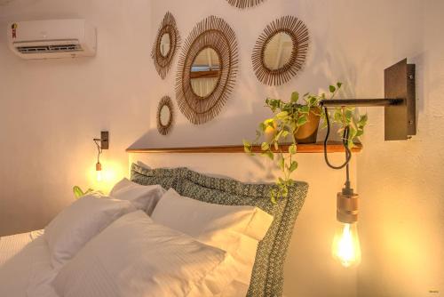 a bedroom with a bed with mirrors on the wall at A Casa de Gabriella in Itacaré