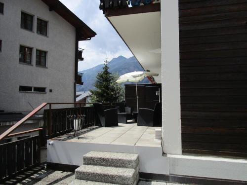 a balcony of a house with a view of a mountain at Touring in Grächen