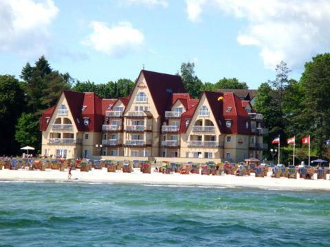 um hotel na praia com a água em frente em Strandhotel Grömitz em Grömitz