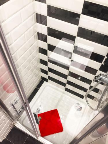 une douche avec une boîte rouge au milieu dans l'établissement Le Glam's Hotel, à Paris