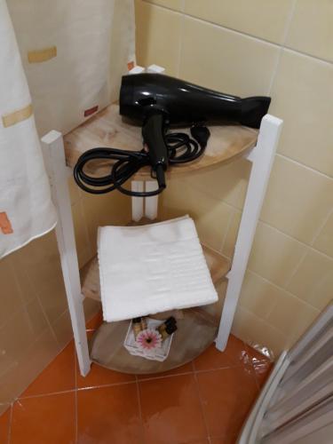 a hair dryer sitting on a shelf in a room at A casa di Simona in Monreale