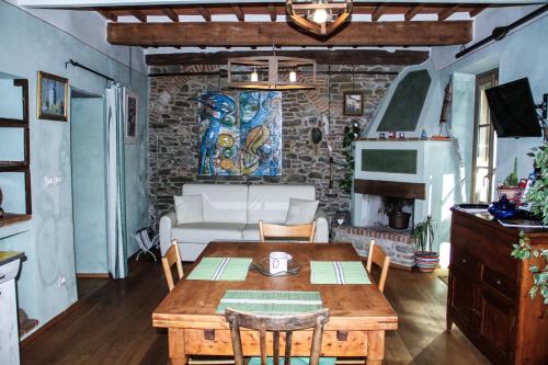 a living room with a wooden table and a brick wall at Residenza Fra Le Torri - Charme & Art Gallery Home in Arezzo
