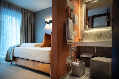 SISSI SUITES | luxury apartments | Mayrhofen في مايرهوفن: غرفه فندقيه بسرير وحمام