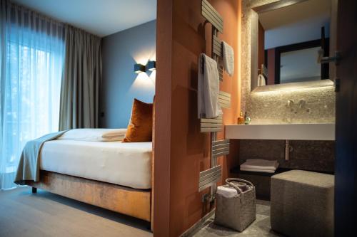 a hotel room with a bed and a bathroom at SISSI SUITES | luxury apartments | Mayrhofen in Mayrhofen