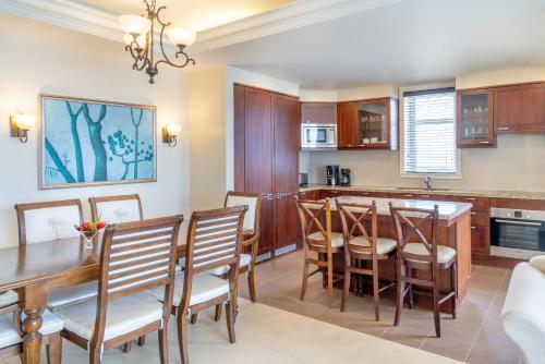 a kitchen and dining room with a wooden table and chairs at Jewel Grande Montego Bay Resort and Spa in Montego Bay