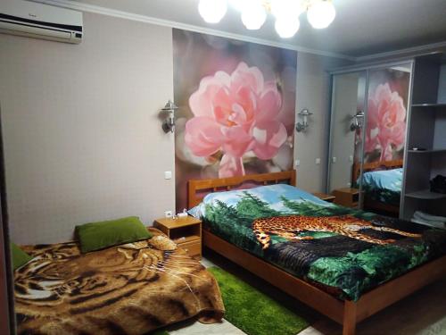 ドニプロにあるАпартаменты Летоの花の絵画が飾られたベッドルーム1室
