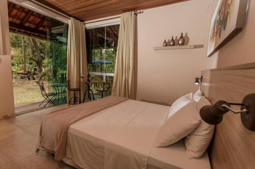 מיטה או מיטות בחדר ב-Pousada Alta Vista - Inhotim