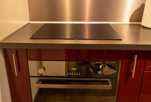 a stove top oven sitting under a counter in a kitchen at Madeleine in Boncourt