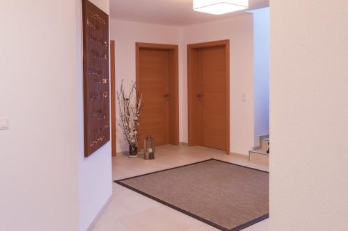 a hallway with two doors and a rug at Apartment im Huggn in Fulpmes